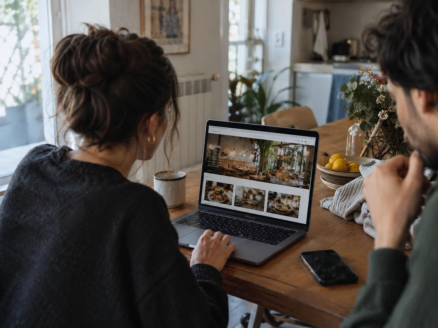 Pareja consultando la web de un restaurante con fotografías de la sala y los platos